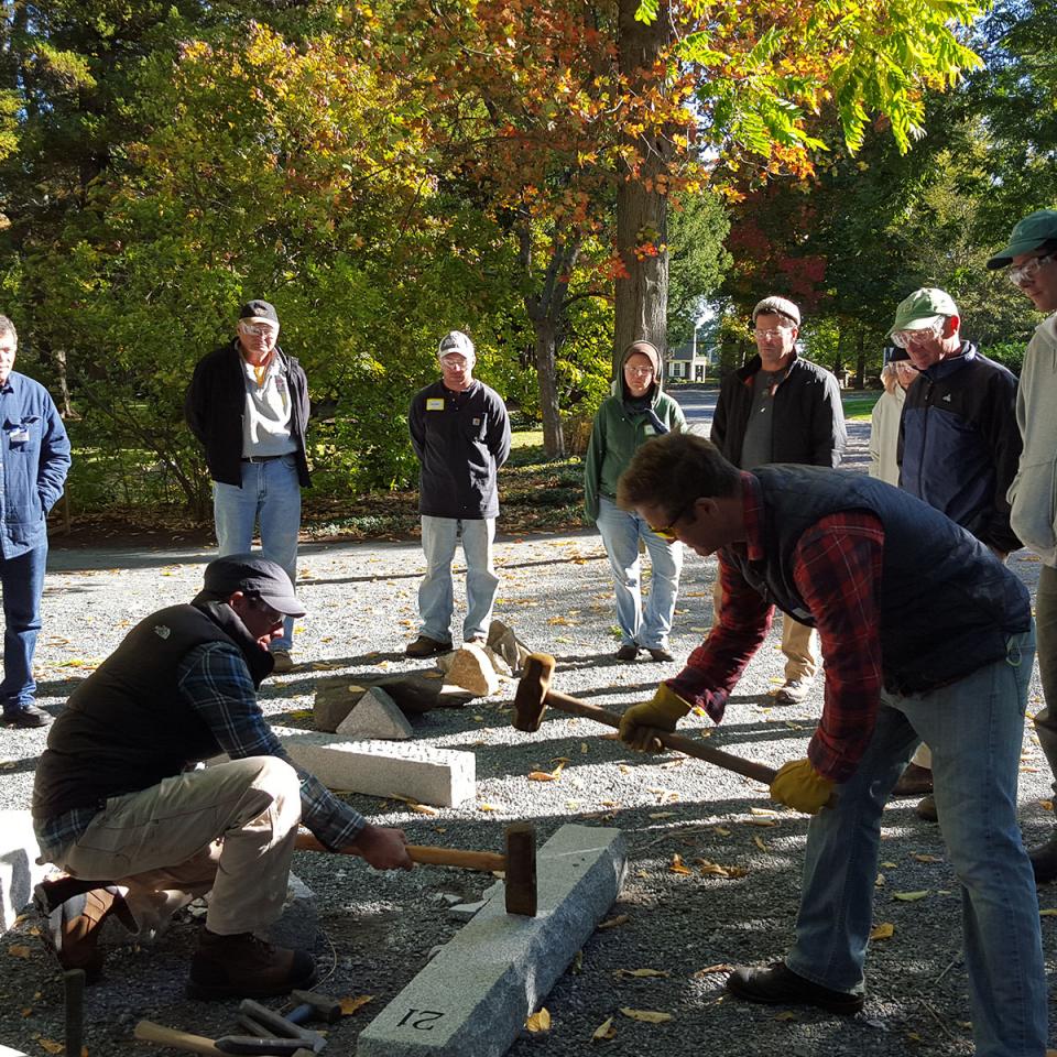 Neil Works With Participants to Split Stone